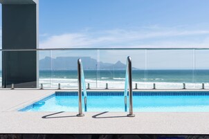 Outdoor pool, open 9:00 AM to 6:00 PM, pool umbrellas, pool loungers