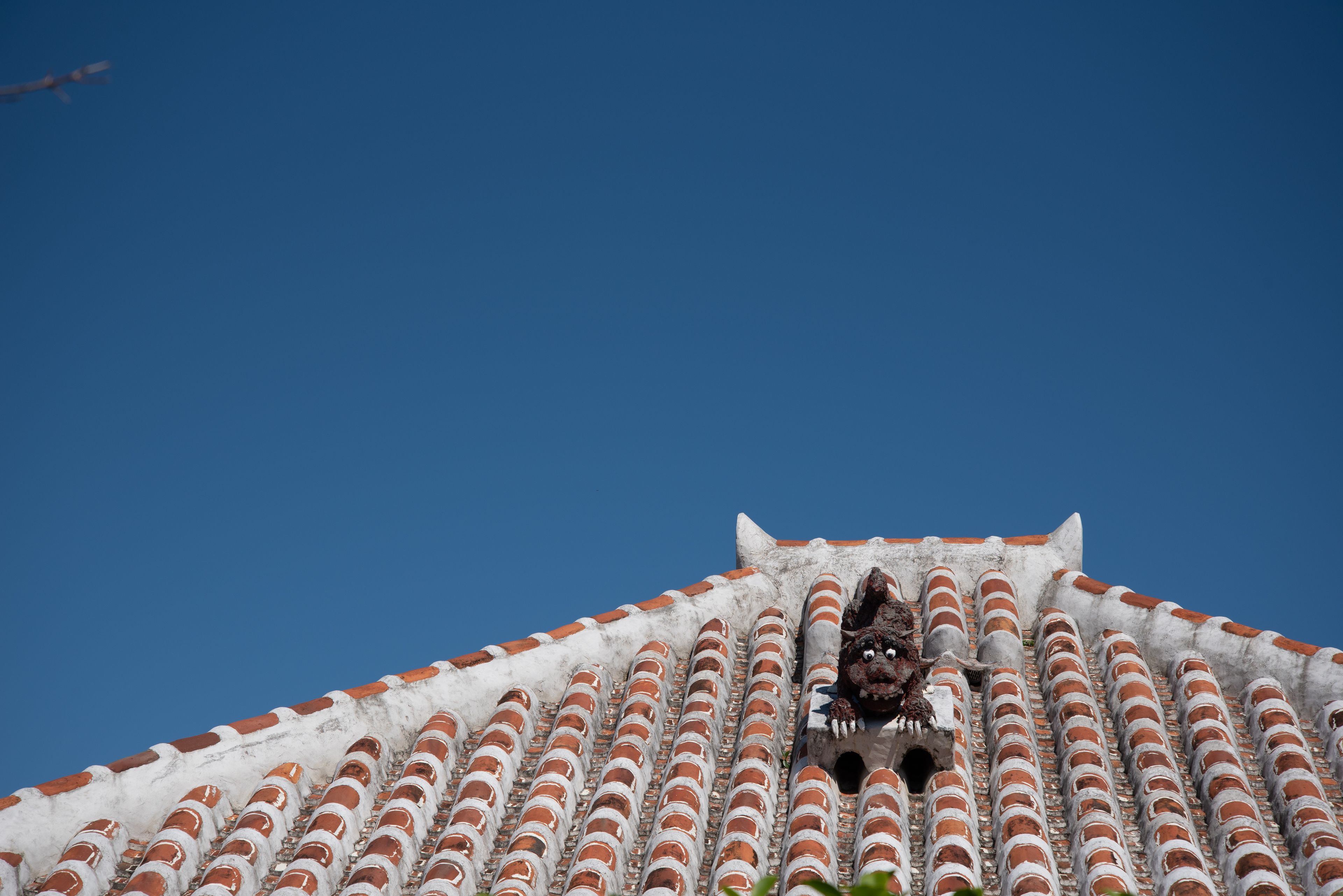 A building with a tiled roof and a small opening.