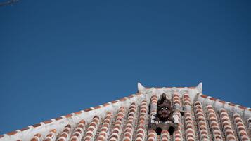 A building with a tiled roof and a small opening.