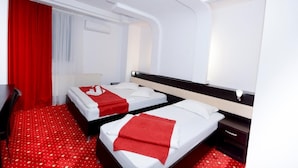 A hotel room with two beds, red curtains, a white ceiling, and a red carpet. - Hotel Magic City Center (Pitesti)