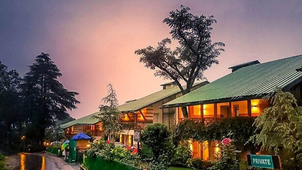 A traditional-style building with a green roof, surrounded by lush greenery and a private sign. - Lamrin Norwood Green Palampur (Palampur)
