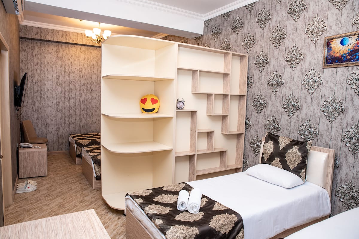 Standard Quadruple Room | Minibar, in-room safe, desk, blackout drapes