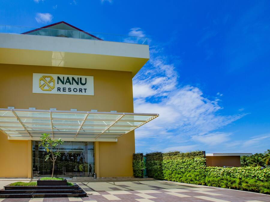 A modern building with a sign reading "NANU RESORT".
