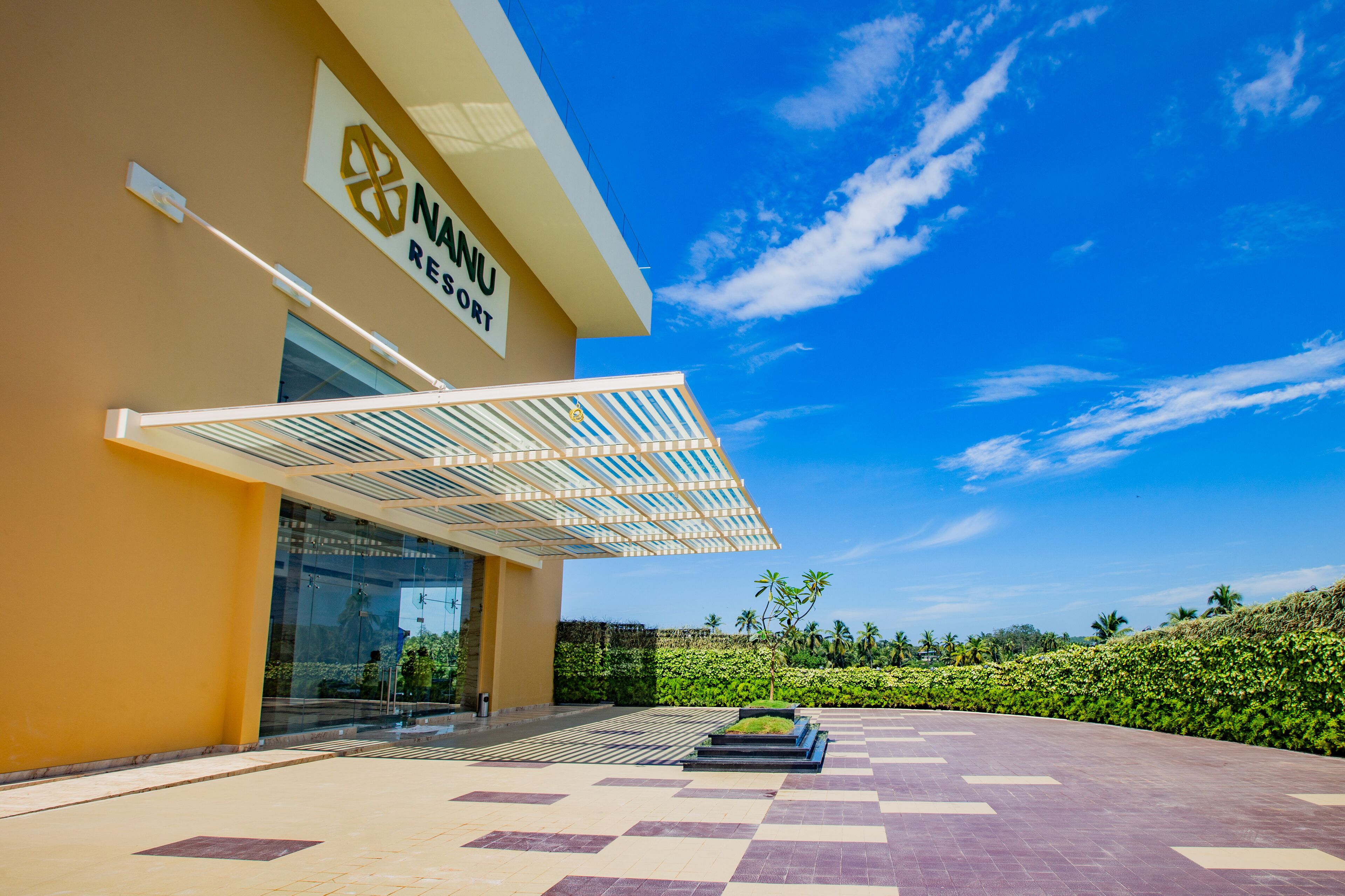 A modern building with a sign reading "NANU RESORT".