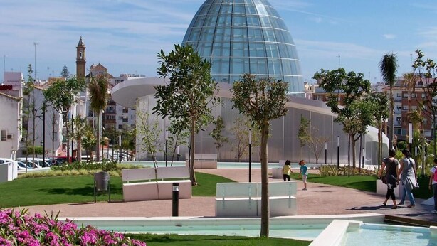 A modern building with a dome structure, surrounded by a landscaped area with benches and a small pool. - Hotel Mare Estepona (Estepona)