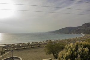 On the beach, sun loungers, beach umbrellas