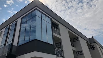 A modern building with large windows and balconies.