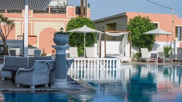Seasonal outdoor pool, open 9:00 AM to 7:00 PM, pool umbrellas