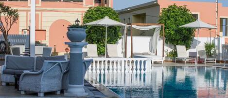 Seasonal outdoor pool, open 9:00 AM to 7:00 PM, pool umbrellas