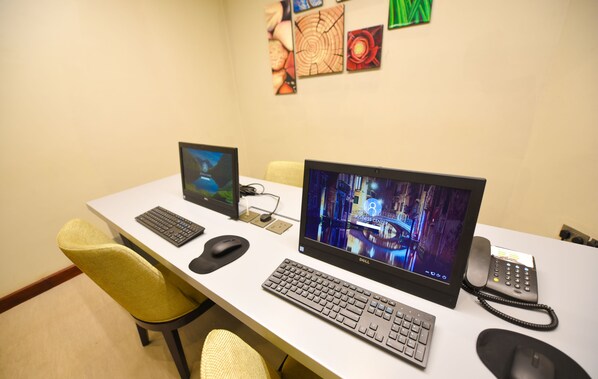 A desk with two monitors, a keyboard, a mouse, and a telephone. - Hilton Garden Inn Kampala (Kampala)