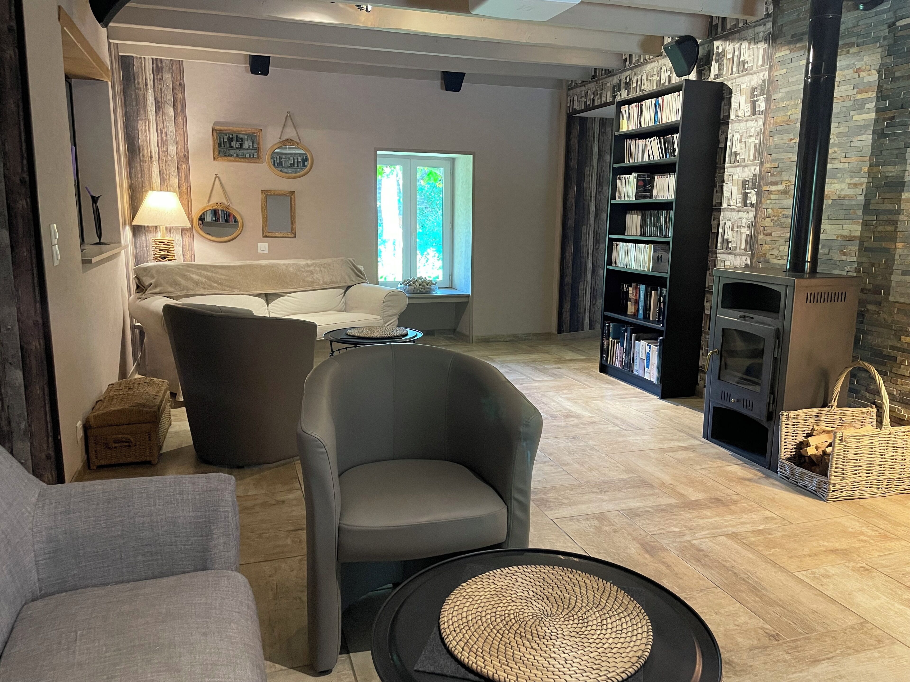 A cozy living room with a fireplace, a sofa, a coffee table, and a bookshelf.
