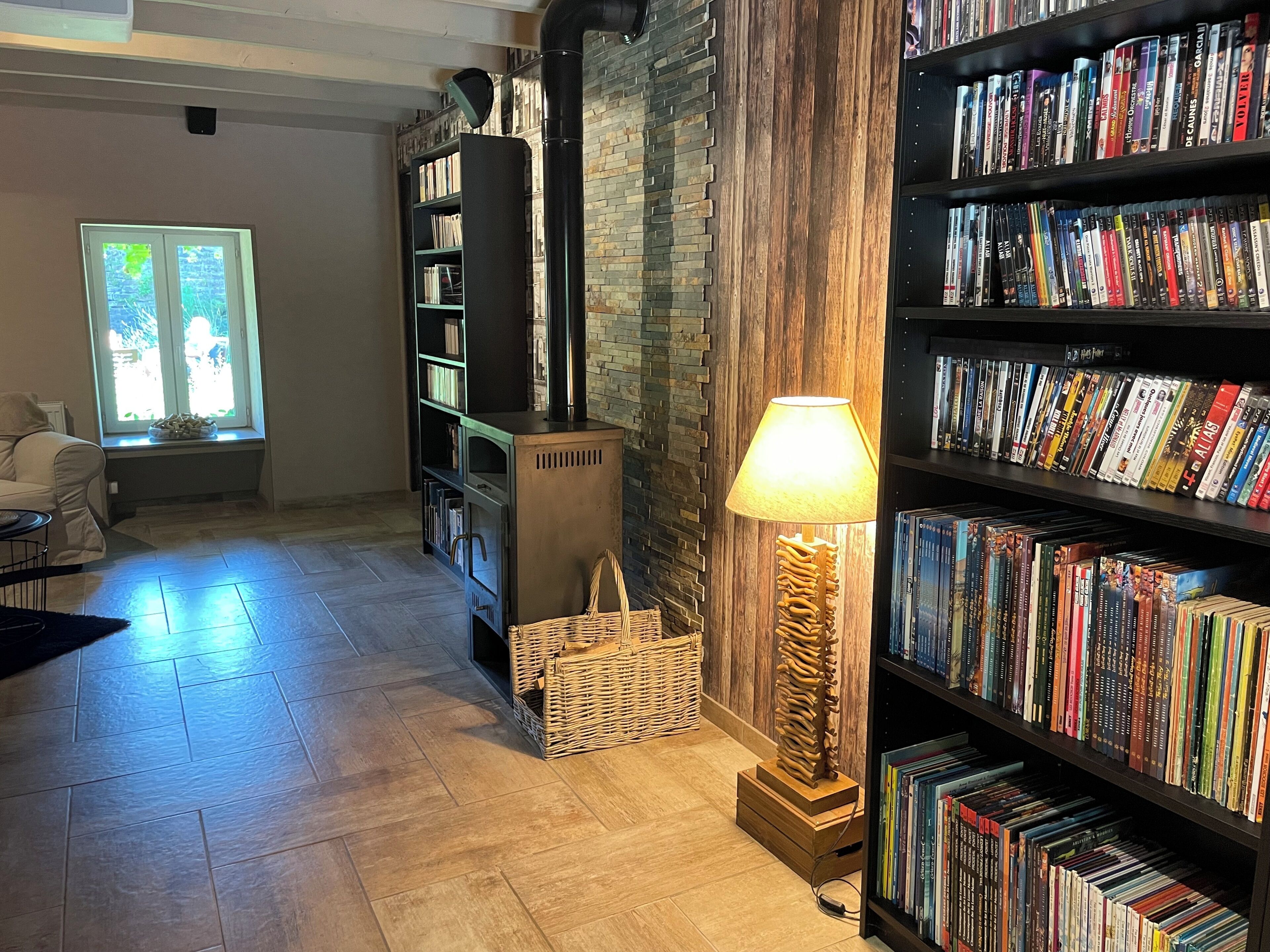 A cozy reading area with a fireplace, bookshelves, and a comfortable seating area.