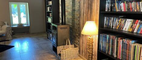 A cozy reading area with a fireplace, bookshelves, and a comfortable seating area.