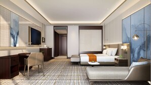 A modern hotel room with a large bed, a desk, a chair, and a TV. - Wyndham Garden Wuhan West (Wuhan)
