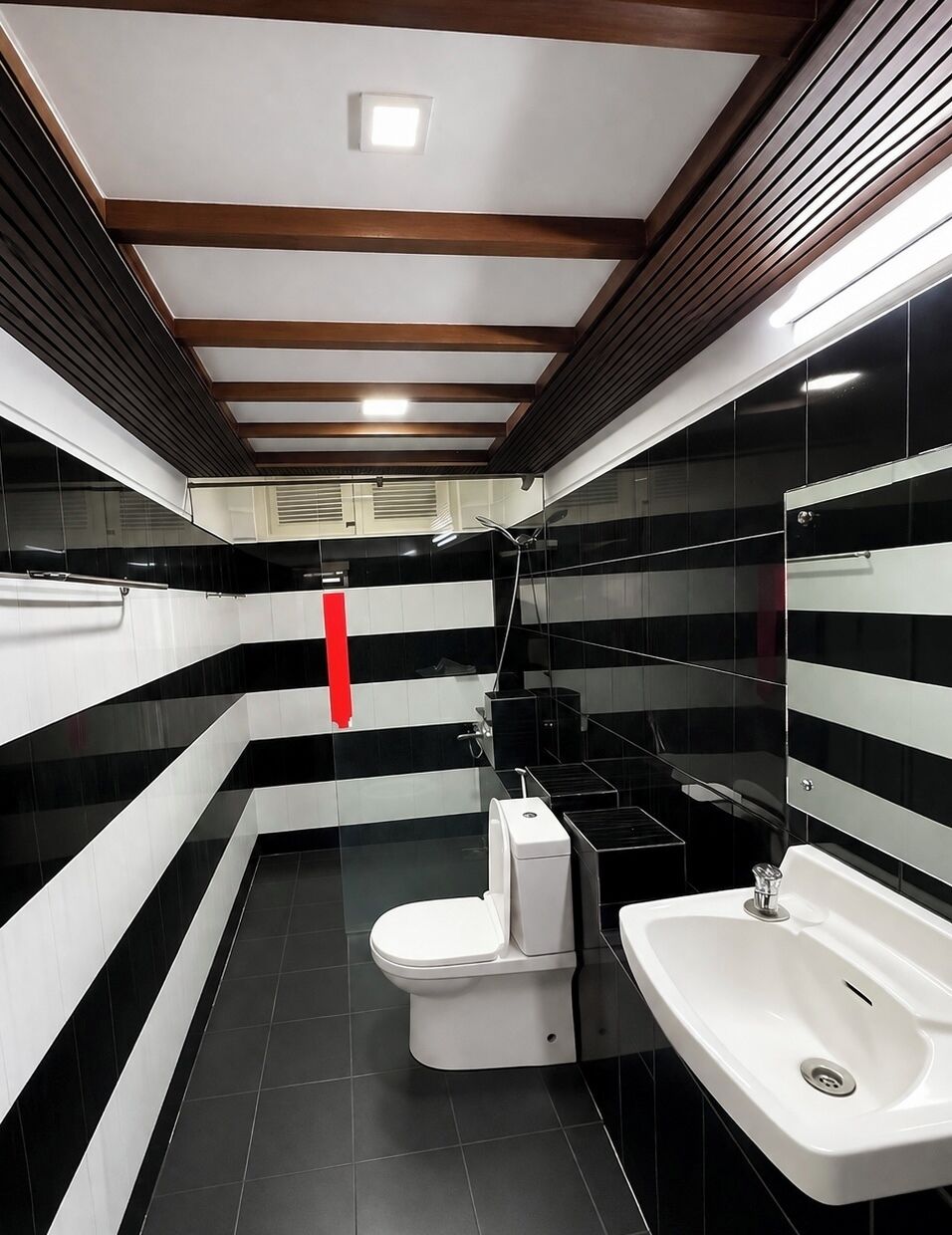 A modern bathroom with a toilet, sink, and shower.