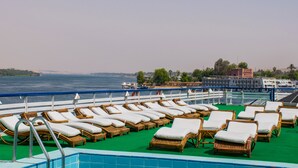 A deck with sun loungers and a pool on a cruise ship. - MS Nephtis Nile Cruise (Luxor)