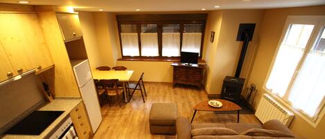 A compact living space with a kitchenette, dining area, and seating area.