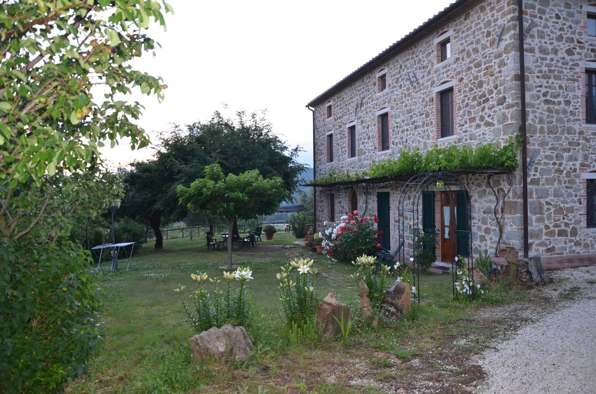 A stone building with a garden in front.