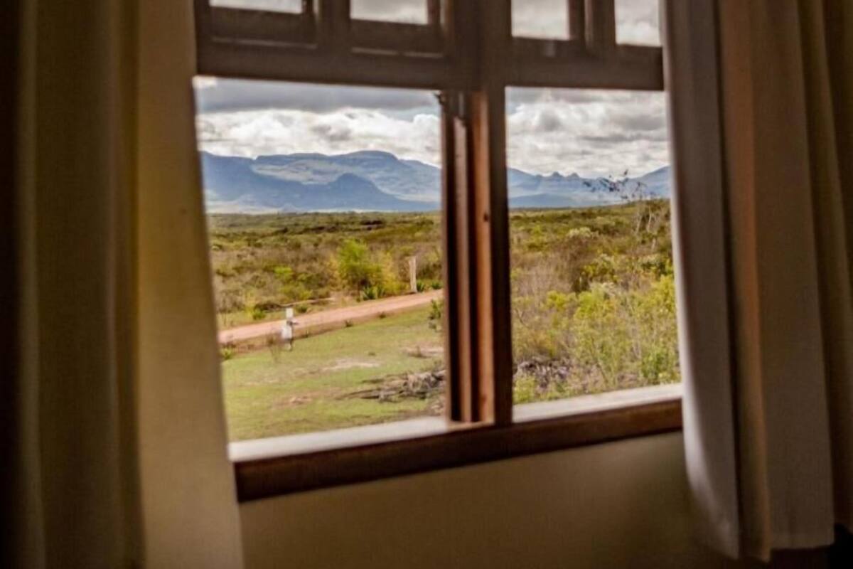A window with a view of a mountainous landscape.