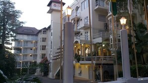 A multi-story hotel with balconies, outdoor lighting, and a central courtyard.