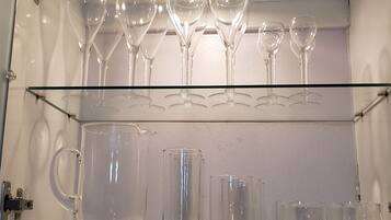 Una vetrina in vetro con bicchieri da vino e bicchieri tumbler.