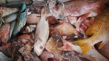 A variety of fish in a container.