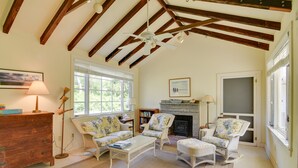 A cozy living room with wooden beams, a fireplace, and comfortable seating. - Mattapoisett Home on 7 Acres w/ Private Beach! (Mattapoisett)