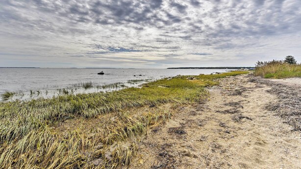 A coastal path with grass and sand, leading to a body of water with boats. - Mattapoisett Home on 7 Acres w/ Private Beach! (Mattapoisett)