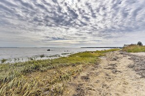 A coastal path with grass and sand, leading to a body of water with boats. - Mattapoisett Home on 7 Acres w/ Private Beach! (Mattapoisett)