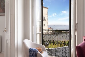 A bright living room with an amazing view over Alfama roofs and Tagus river