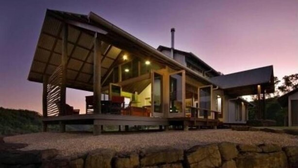 A modern house with an open design, featuring a large deck and multiple windows. - Off grid tranquillity with beautiful views and no other house in sight (Mapleton)