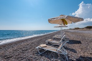 On the beach, sun-loungers, beach umbrellas, beach towels