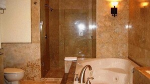 A bathroom with a large bathtub, a shower, and a toilet. - Downtown Cabo San Lucas Suite with Ocean and Harbor Views (Cabo)