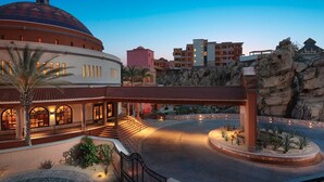 A hotel with a large dome, a central courtyard, and a rocky landscape. - Downtown Cabo San Lucas Suite with Ocean and Harbor Views (Cabo)