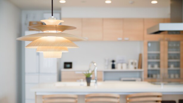 A modern kitchen with a central island, pendant lighting, and wooden chairs. - Jstyle STAY Furano (Furano)