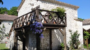 A stone building with a wooden balcony.