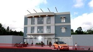 A modern multi-story building with a cafe named 'Cafe' on the ground floor. - Rana Hotel (Cebu City)