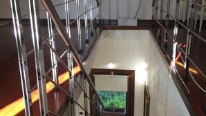 A staircase with metal railings and wooden steps leading to a landing.
