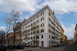 A multi-story building with a classic architectural style, featuring a symmetrical facade with evenly spaced windows and a central entrance.