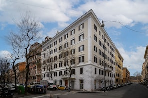 A multi-story building with a classic architectural style, featuring a symmetrical facade with evenly spaced windows and a central entrance. - Suite Apartment Prati (Roma)
