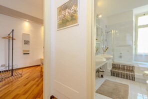 A modern bathroom with a shower, sink, and toilet.