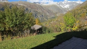 A mountainous landscape with a small cabin surrounded by greenery and a clear sky. - 5 star chalet with stunning views, top location, free Wi-Fi, ski-in-ski-out (Bellwald)