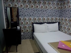 Un dormitorio con una cama, un aparador y un espejo.