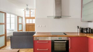 A compact kitchen with a built-in oven, a small sink, and a wooden countertop. - Suit Du Lion/AC Historic Flat, Marais, 4-5 Guests (Paris)