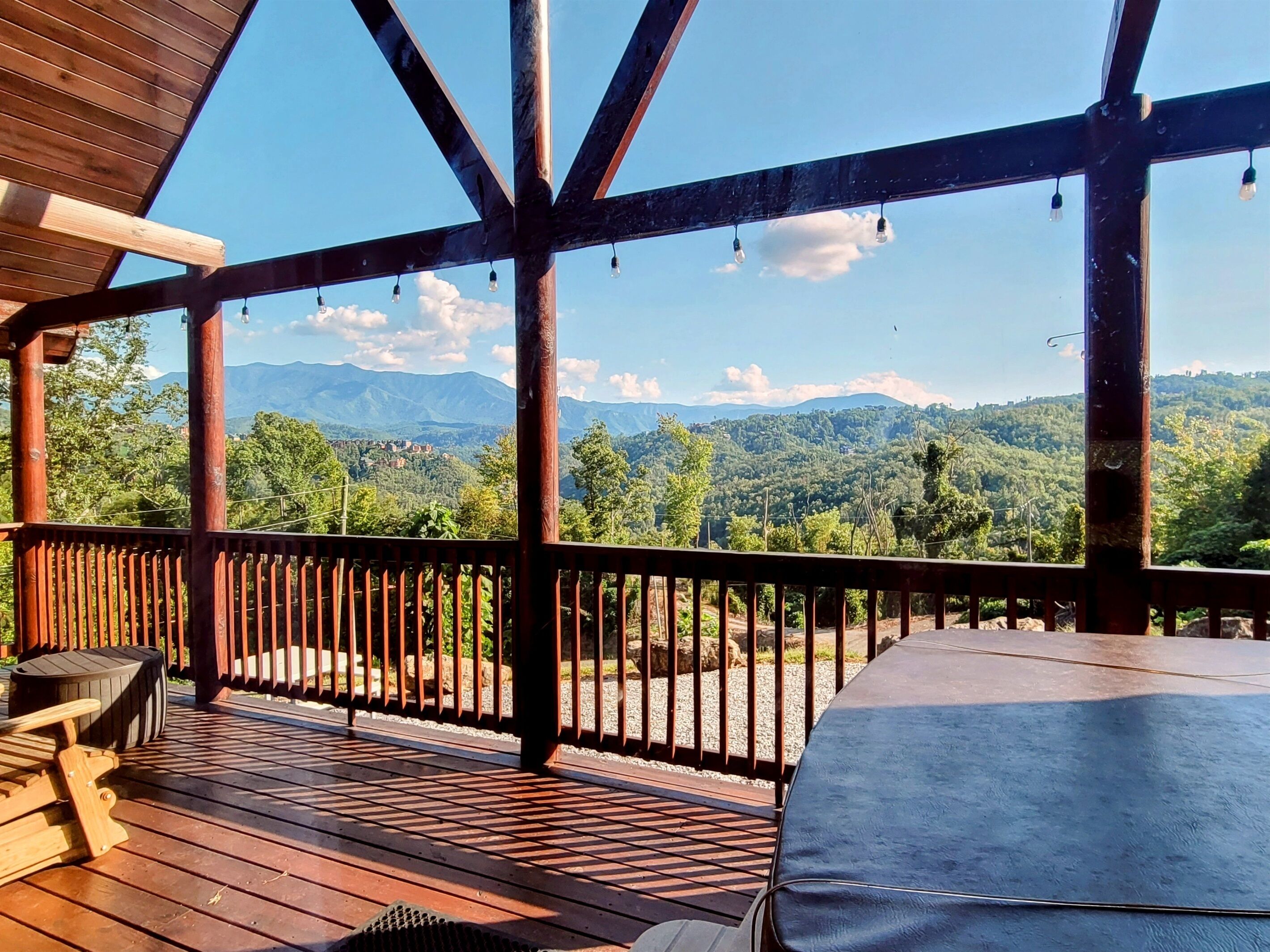 A wooden deck with a view of a mountainous landscape.