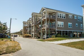 A multi-story residential building with balconies and a covered walkway. - Sea Lookout - Great last-minute rates with ocean views. June 27-July 4! (Atlantic Beach)