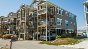 A multi-story residential building with balconies, a covered parking area, and a visible mailbox. - Sea Lookout - Great last-minute rates with ocean views. June 27-July 4! (Atlantic Beach)