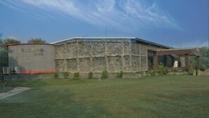 A building with a sign reading "SCORPIO CLUB" and a covered outdoor area with a statue. - Scorpio Clubs & Resorts (Bakshi Ka Talab)