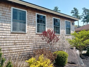 A two-story house with a shingle exterior and three windows. - A Spacious Vacation Cottage in Sheepscot Harbour (Edgecomb)