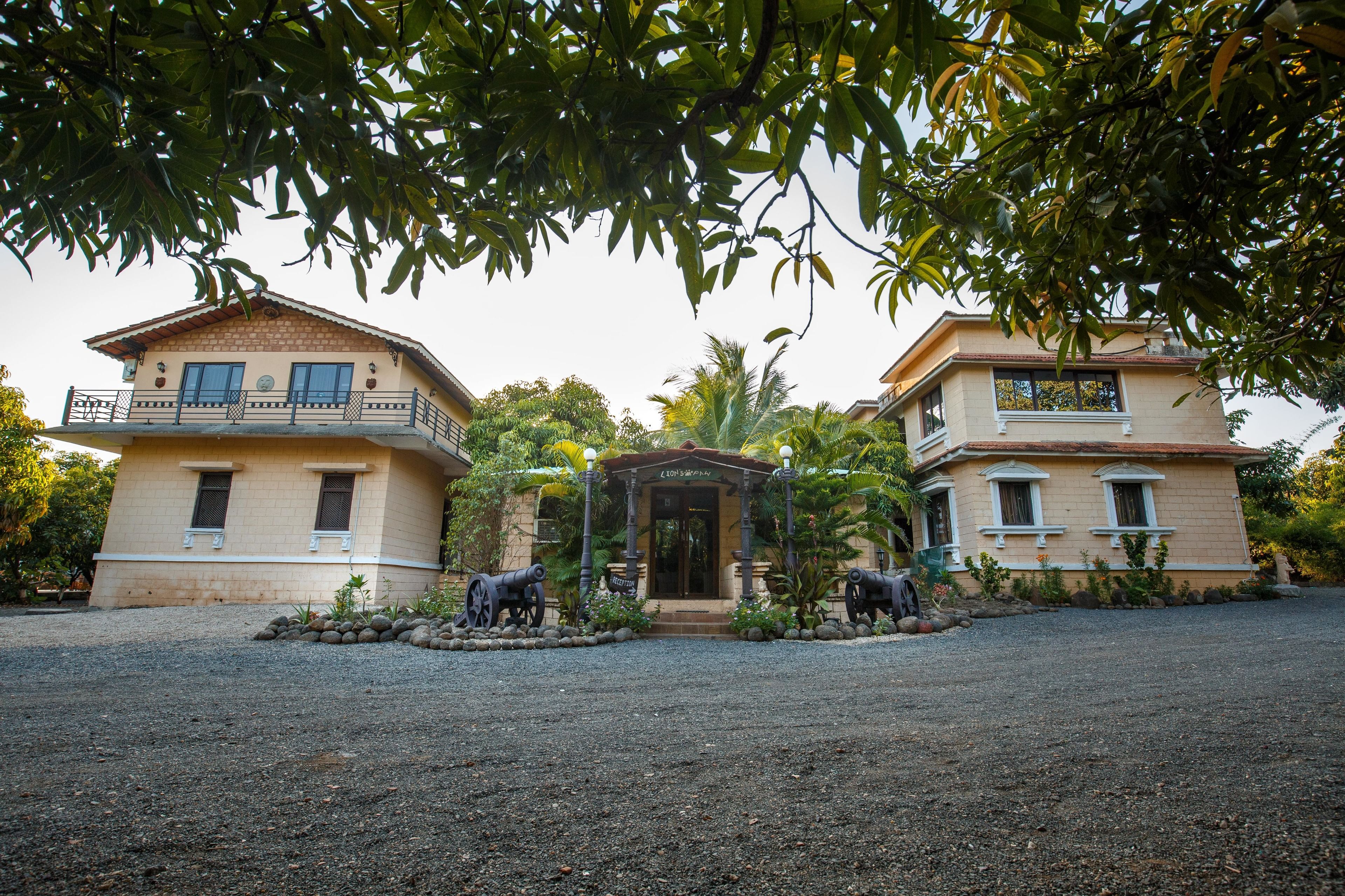 A two-story building with a balcony and a covered entrance.